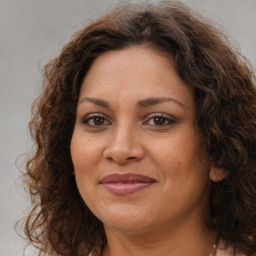 Joyful white adult female with long  brown hair and brown eyes