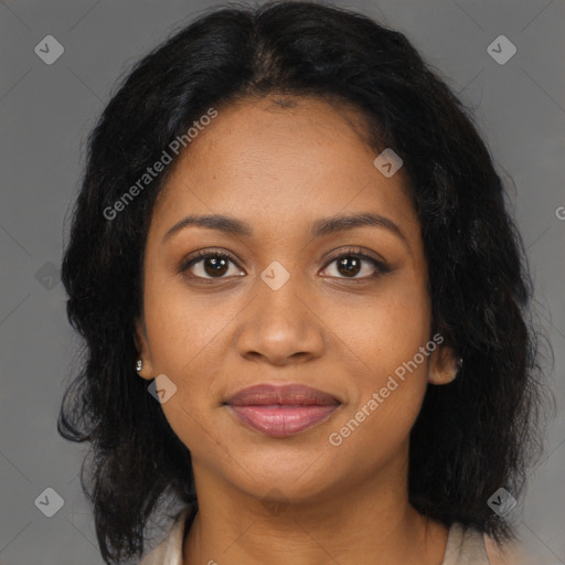 Joyful black young-adult female with long  brown hair and brown eyes