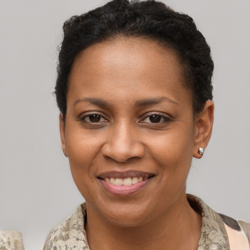 Joyful black young-adult female with short  brown hair and brown eyes