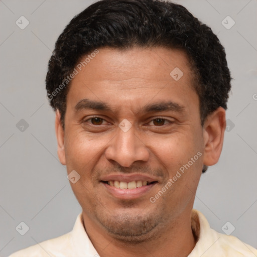 Joyful latino adult male with short  brown hair and brown eyes