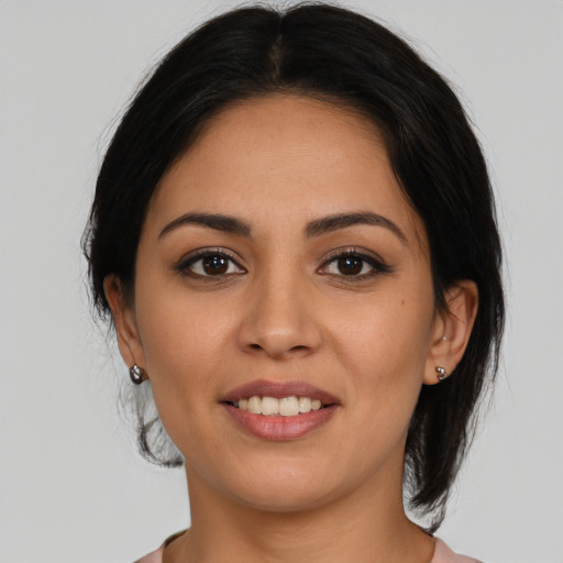 Joyful latino young-adult female with medium  brown hair and brown eyes