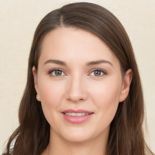 Joyful white young-adult female with long  brown hair and brown eyes