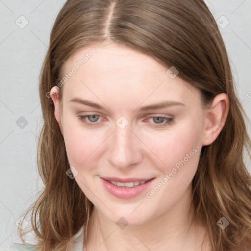 Joyful white young-adult female with long  brown hair and blue eyes