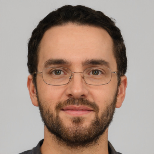 Joyful white adult male with short  brown hair and brown eyes