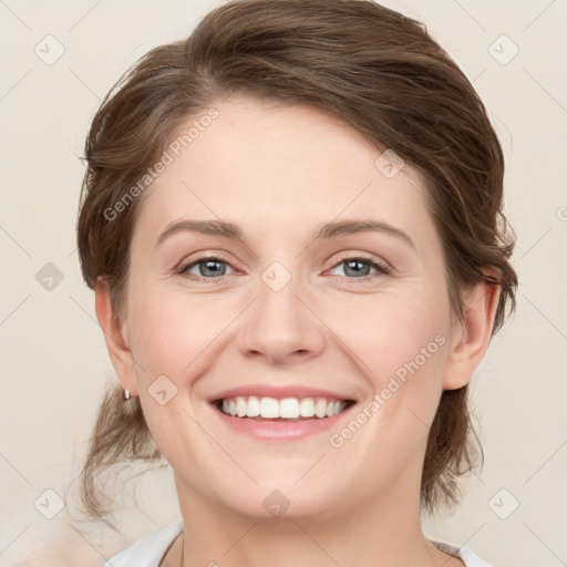 Joyful white young-adult female with medium  brown hair and green eyes