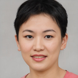 Joyful asian young-adult female with short  brown hair and brown eyes