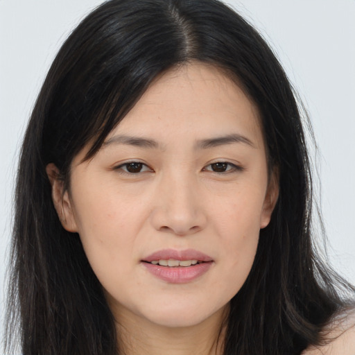 Joyful asian young-adult female with long  brown hair and brown eyes