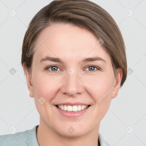 Joyful white young-adult female with short  brown hair and grey eyes