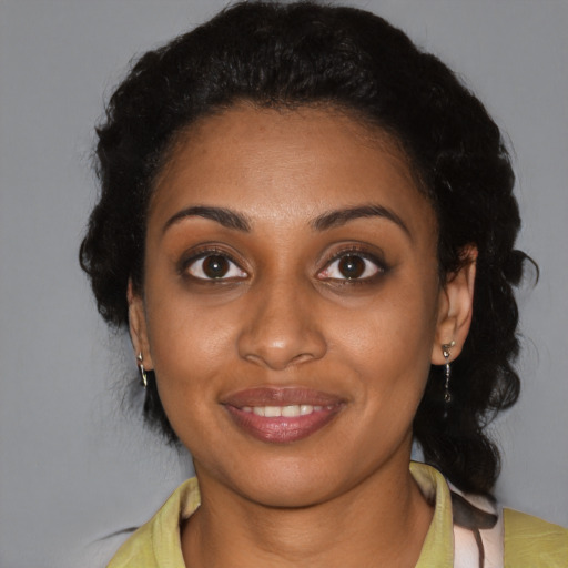 Joyful black young-adult female with medium  black hair and brown eyes
