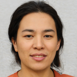 Joyful asian young-adult female with medium  brown hair and brown eyes