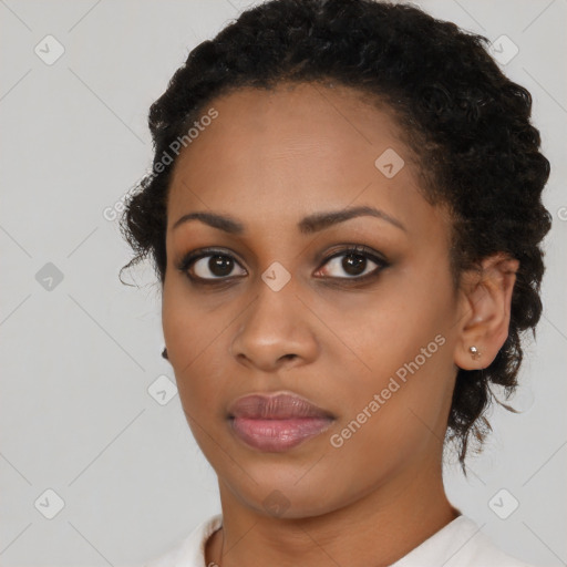 Joyful black young-adult female with short  black hair and brown eyes