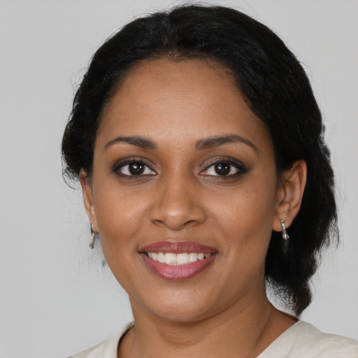 Joyful black young-adult female with medium  black hair and brown eyes