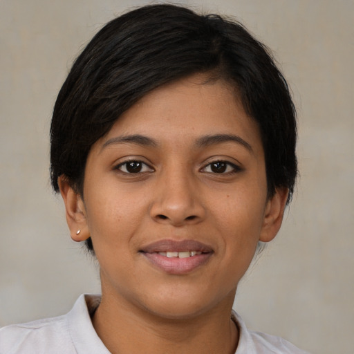 Joyful latino young-adult female with short  brown hair and brown eyes