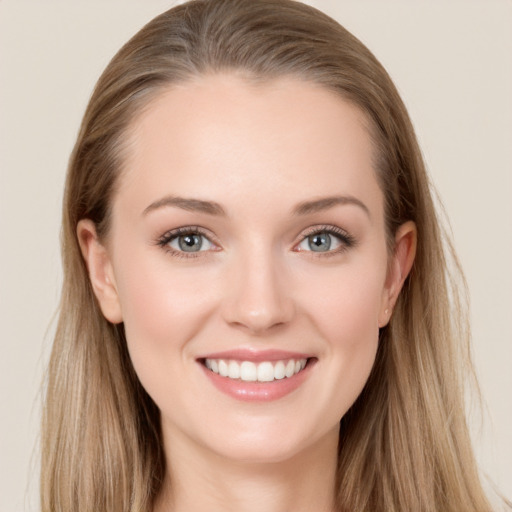 Joyful white young-adult female with long  brown hair and grey eyes