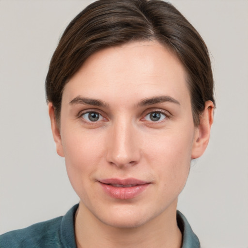 Joyful white young-adult female with short  brown hair and grey eyes