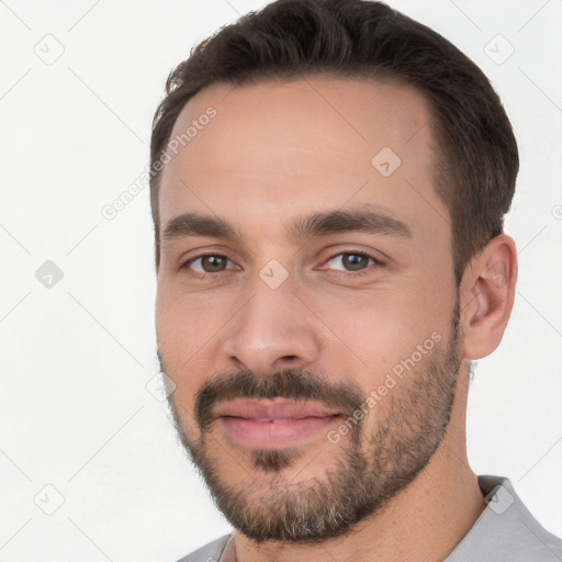 Joyful white young-adult male with short  brown hair and brown eyes