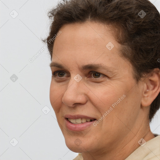 Joyful white adult female with short  brown hair and brown eyes