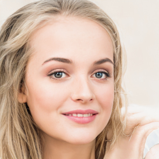 Joyful white young-adult female with long  brown hair and blue eyes