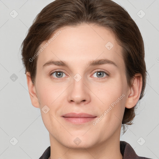 Joyful white young-adult female with short  brown hair and grey eyes