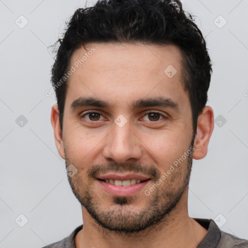 Joyful white young-adult male with short  black hair and brown eyes