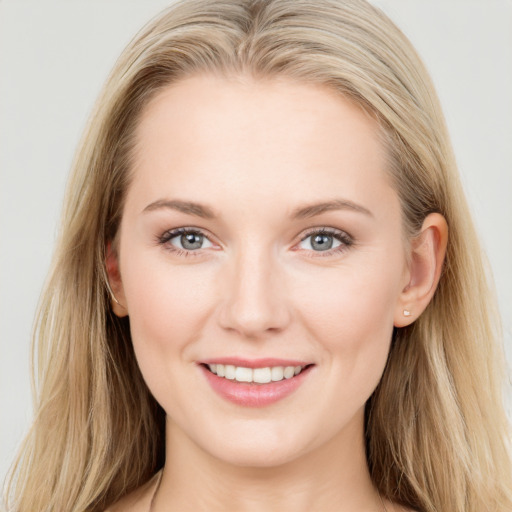 Joyful white young-adult female with long  brown hair and blue eyes