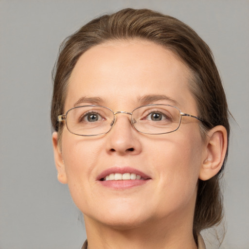 Joyful white adult female with medium  brown hair and blue eyes