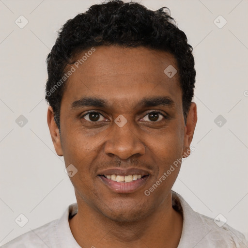 Joyful black young-adult male with short  black hair and brown eyes