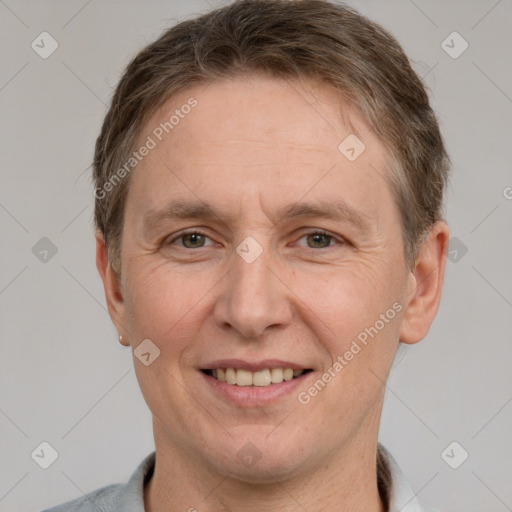 Joyful white adult male with short  brown hair and grey eyes