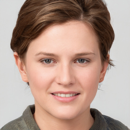 Joyful white young-adult female with medium  brown hair and blue eyes