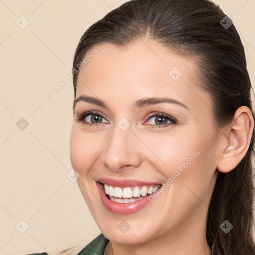 Joyful white young-adult female with long  brown hair and brown eyes