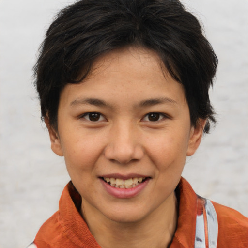 Joyful asian young-adult female with short  brown hair and brown eyes