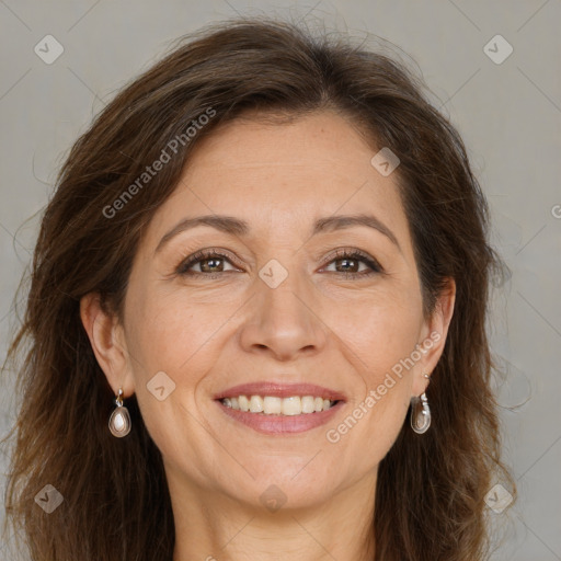 Joyful white adult female with long  brown hair and brown eyes