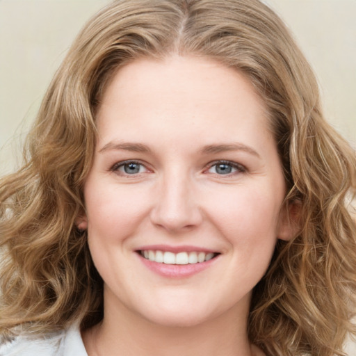 Joyful white young-adult female with medium  brown hair and blue eyes