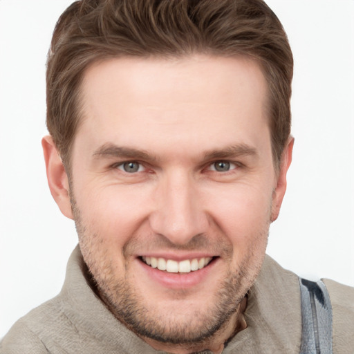 Joyful white young-adult male with short  brown hair and grey eyes