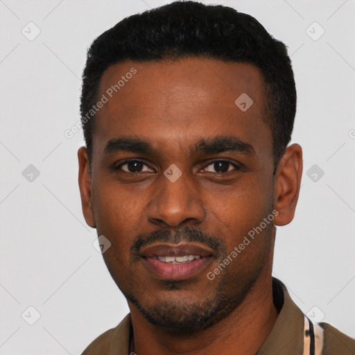 Joyful black young-adult male with short  black hair and brown eyes