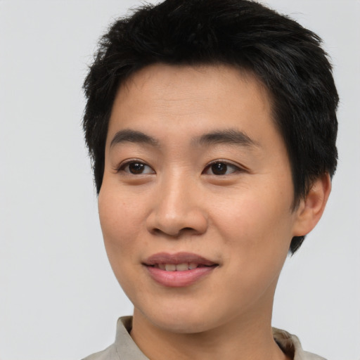 Joyful asian young-adult male with short  brown hair and brown eyes