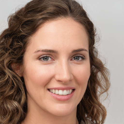 Joyful white young-adult female with long  brown hair and green eyes