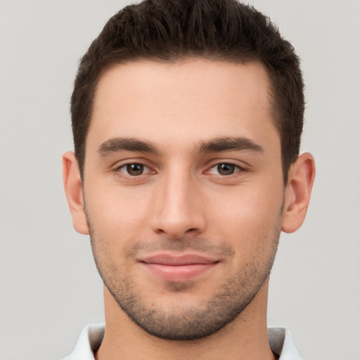 Joyful white young-adult male with short  brown hair and brown eyes