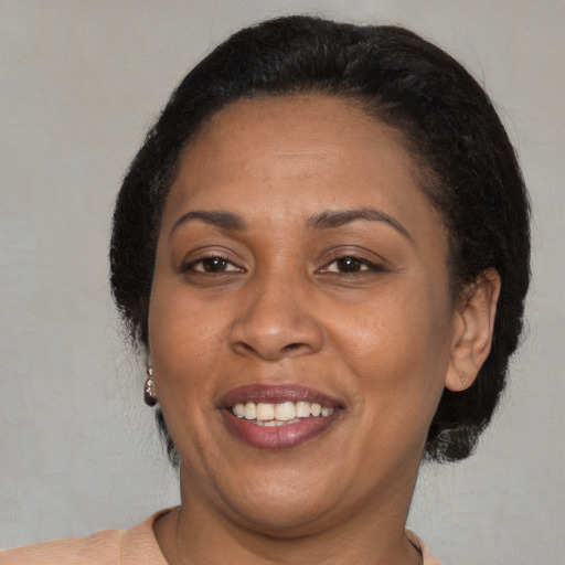 Joyful latino adult female with short  black hair and brown eyes