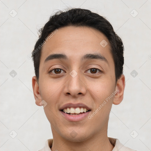 Joyful white young-adult male with short  black hair and brown eyes