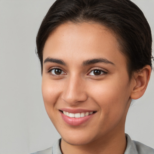 Joyful white young-adult female with short  brown hair and brown eyes