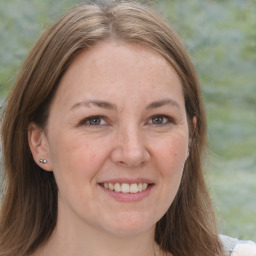 Joyful white adult female with medium  brown hair and brown eyes