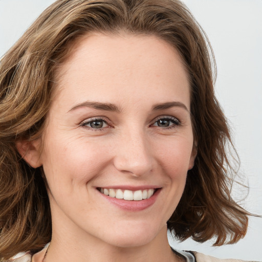 Joyful white young-adult female with medium  brown hair and blue eyes