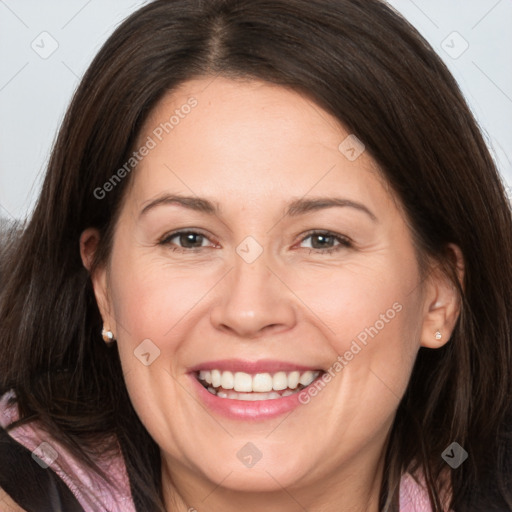 Joyful white adult female with long  brown hair and brown eyes