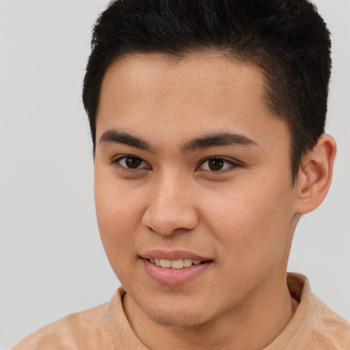 Joyful latino young-adult male with short  brown hair and brown eyes