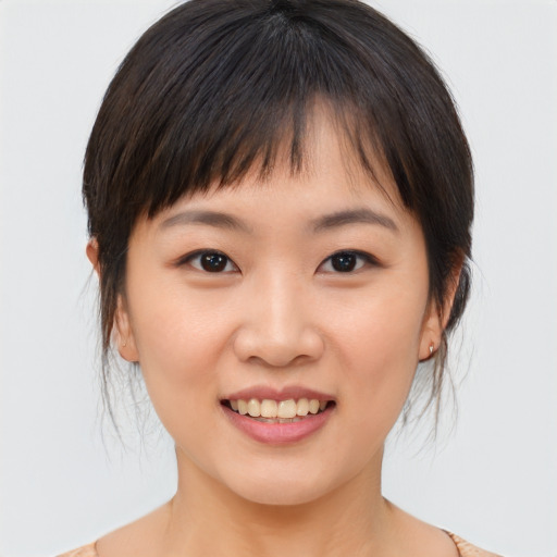 Joyful asian young-adult female with medium  brown hair and brown eyes