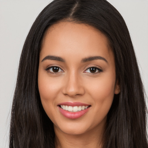 Joyful white young-adult female with long  black hair and brown eyes