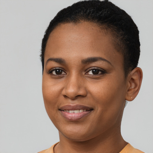 Joyful black young-adult female with short  brown hair and brown eyes