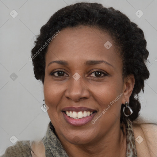 Joyful black adult female with short  brown hair and brown eyes