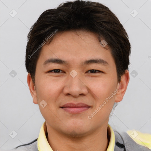 Joyful asian young-adult male with short  brown hair and brown eyes